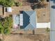 Overhead aerial view of a pool and screened patio, fenced yard, and shed at 5155 Baldock Ave, Spring Hill, FL 34608
