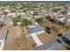 Aerial view of a property with a well-kept lawn, pool and screen, and mature trees at 5155 Baldock Ave, Spring Hill, FL 34608