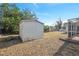 Backyard featuring a storage shed adjacent to a screened in porch at 5155 Baldock Ave, Spring Hill, FL 34608