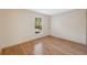 Cozy bedroom has wood floors, a window providing natural light, and recessed shelving on the wall at 5155 Baldock Ave, Spring Hill, FL 34608