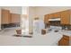 Well-lit kitchen with wood cabinets, mosaic backsplash, white appliances, and white countertops at 5155 Baldock Ave, Spring Hill, FL 34608