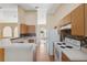 Kitchen with white countertops, stainless steel sink and faucet, oak cabinets and mosaic tile backsplash at 5155 Baldock Ave, Spring Hill, FL 34608