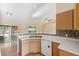 Bright kitchen featuring white appliances and a breakfast bar overlooking the living area at 5155 Baldock Ave, Spring Hill, FL 34608