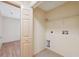 Small laundry room has tile floors, washer/dryer hookups, and a wire shelf for storage at 5155 Baldock Ave, Spring Hill, FL 34608