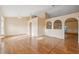 Open-concept living area with light walls, wood-look floors and decorative archways at 5155 Baldock Ave, Spring Hill, FL 34608