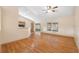 Open-concept living room with hardwood floors and sliding glass doors leading to an outdoor space at 5155 Baldock Ave, Spring Hill, FL 34608