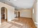 Open living space featuring light walls, wood-look floors and decorative archways to other rooms at 5155 Baldock Ave, Spring Hill, FL 34608