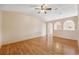 Open living room with hardwood floors, arched entryways, and plenty of natural light at 5155 Baldock Ave, Spring Hill, FL 34608