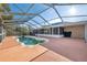 Relax in the sun and fun with this screened-in pool surrounded by a spacious deck at 5155 Baldock Ave, Spring Hill, FL 34608