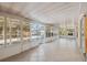 Enclosed sunroom overlooks pool and yard with access through multiple sliding glass doors at 5155 Baldock Ave, Spring Hill, FL 34608