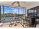 Enclosed balcony with tile flooring, bar, and expansive views of the canal at 5640 Ferguson Ct # 2208, New Port Richey, FL 34652