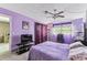 Bright bedroom with lavender walls, tile flooring and modern furnishings at 5640 Ferguson Ct # 2208, New Port Richey, FL 34652