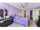Bright bedroom with lavender walls, tile flooring and modern furnishings at 5640 Ferguson Ct # 2208, New Port Richey, FL 34652