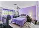 Bright bedroom with lavender walls, tile flooring and modern furnishings at 5640 Ferguson Ct # 2208, New Port Richey, FL 34652