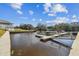 Condo waterfront featuring a boat dock with several boats on a sunny day with blue skies at 5640 Ferguson Ct # 2208, New Port Richey, FL 34652