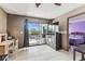 Cozy living area with a desk, TV, and a balcony view of the lake at 5640 Ferguson Ct # 2208, New Port Richey, FL 34652