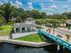 Scenic riverfront view of New Port Richey, featuring bridge, gazebo, and verdant landscaping under a partly cloudy sky at 5640 Ferguson Ct # 2208, New Port Richey, FL 34652