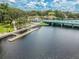 Aerial view of waterway featuring dock access, bridge, waterfront businesses and downtown access at 5640 Ferguson Ct # 2208, New Port Richey, FL 34652