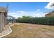 Spacious backyard featuring a screen-enclosed patio and lush privacy hedge at 6112 Kinlock Ave, Spring Hill, FL 34608