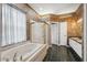 Lavish bathroom with a soaking tub, glass shower, and dual sinks at 6112 Kinlock Ave, Spring Hill, FL 34608