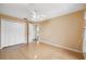 Bedroom with a ceiling fan, hardwood floors, and a closet at 6112 Kinlock Ave, Spring Hill, FL 34608
