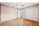Bedroom with hardwood floors, a ceiling fan, closet doors, and floral wallpaper border at 6112 Kinlock Ave, Spring Hill, FL 34608