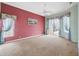 Spacious bedroom with natural light, ceiling fan, and sliding door access to the backyard at 6112 Kinlock Ave, Spring Hill, FL 34608