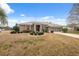 Inviting single-story home with lush landscaping and an appealing front yard at 6112 Kinlock Ave, Spring Hill, FL 34608