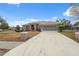 Charming single-story home with a long driveway and well-maintained landscaping at 6112 Kinlock Ave, Spring Hill, FL 34608