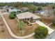 Aerial view of charming single-story home with tile roof and manicured landscaping at 6112 Kinlock Ave, Spring Hill, FL 34608