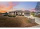 Charming single-story home featuring manicured landscaping, a two-car garage, and a warm, inviting entryway at 6112 Kinlock Ave, Spring Hill, FL 34608