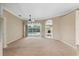 Bright and airy living room with a view of the backyard pool and an archway to another room at 6112 Kinlock Ave, Spring Hill, FL 34608