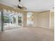 Bright living room with views of the pool and a large sliding glass door leading to the patio at 6112 Kinlock Ave, Spring Hill, FL 34608