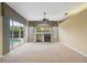 Bright living room with fireplace, ceiling fan, and sliding door access to the pool at 6112 Kinlock Ave, Spring Hill, FL 34608