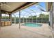Screened-in pool with a covered patio and an outdoor kitchenette, perfect for relaxing and entertaining at 6112 Kinlock Ave, Spring Hill, FL 34608