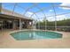 Screened-in pool and patio area, with nearby landscaping and sliding glass doors at 6112 Kinlock Ave, Spring Hill, FL 34608