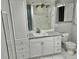 Updated bathroom with white cabinets and marble-look tile at 6401 Drexel Dr # 1, Port Richey, FL 34668
