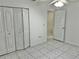 Bright bedroom with double door closet and tile floor at 6401 Drexel Dr # 1, Port Richey, FL 34668