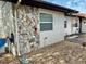 Exterior side view with stone wall and window at 6401 Drexel Dr # 1, Port Richey, FL 34668
