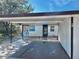 Exterior view of a single-story home with carport and landscaping at 6401 Drexel Dr # 1, Port Richey, FL 34668