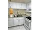 White kitchen with stainless steel sink and appliances at 6401 Drexel Dr # 1, Port Richey, FL 34668
