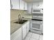 White kitchen with stainless steel sink and appliances at 6401 Drexel Dr # 1, Port Richey, FL 34668