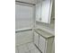 Kitchen features white cabinets and a window with blinds at 6401 Drexel Dr # 1, Port Richey, FL 34668