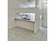 Kitchen with white cabinets, a double sink, and tiled floors at 6401 Drexel Dr # 1, Port Richey, FL 34668