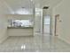 Bright kitchen features a breakfast bar and tile flooring at 6401 Drexel Dr # 1, Port Richey, FL 34668