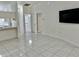 Living room with tile floors, and views into kitchen and bathroom at 6401 Drexel Dr # 1, Port Richey, FL 34668