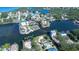 Aerial view of a waterfront residential neighborhood with boat docks and waterways at 6801 Nowiki Ave, Hudson, FL 34667