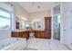 Bright bathroom featuring double vanity, soaking tub, walk-in shower, and modern lighting at 6801 Nowiki Ave, Hudson, FL 34667