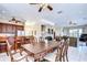 Open-concept dining area featuring a large wood table and seamless flow to the kitchen at 6801 Nowiki Ave, Hudson, FL 34667