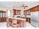 Open kitchen with granite countertops, stainless steel appliances, and barstool seating at 6801 Nowiki Ave, Hudson, FL 34667